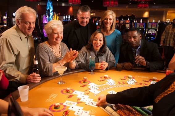 A group playing poker in a casino near Pearl River Resorts