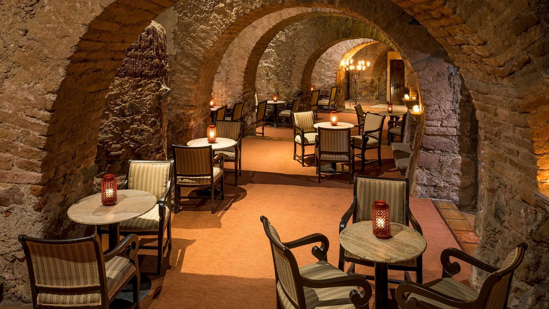 Bar Botarel featuring red lanterns and stone archways in a unique circular layout at Quinta Real Zacatecas