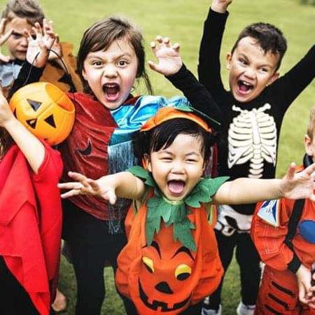 a group of kids dressed in halloween costumes