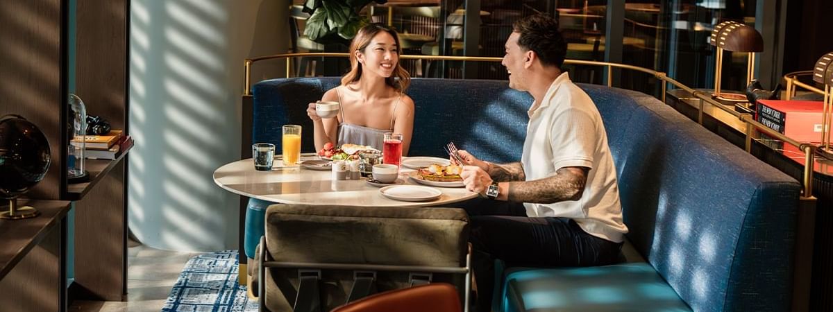 Couple enjoying their meals in a Restaurant at Pullman Sydney Olympic Park