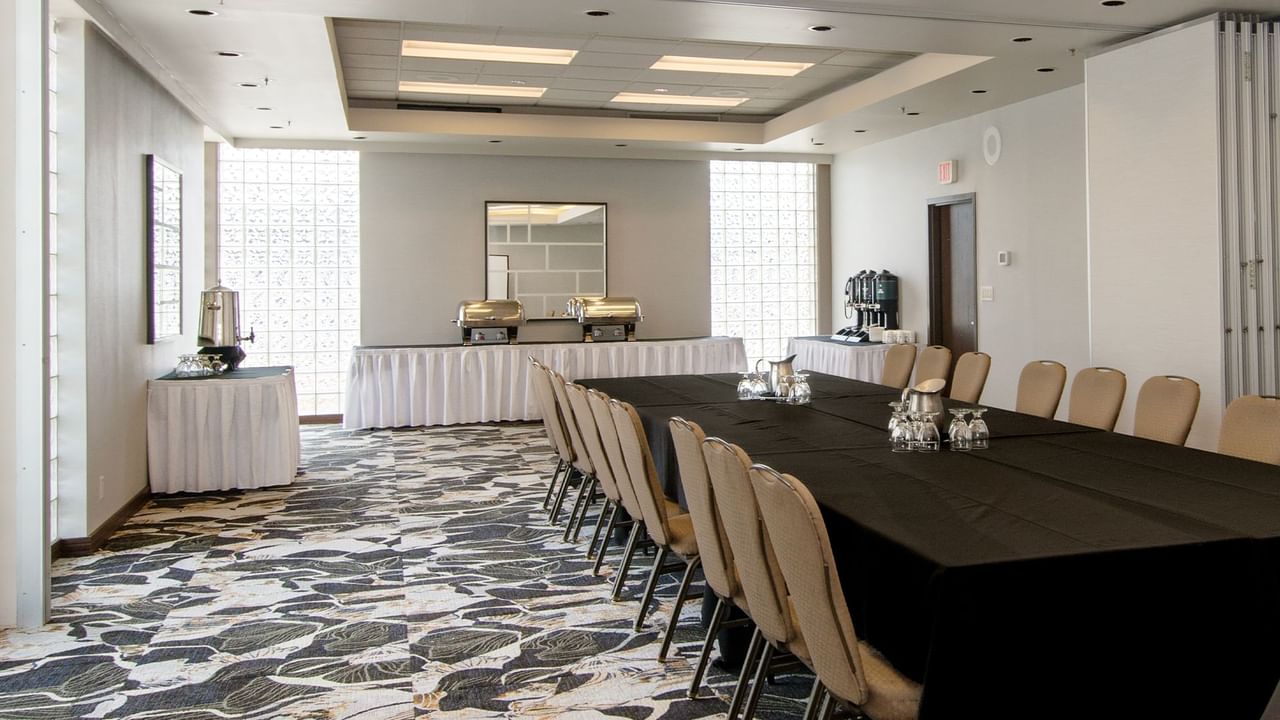 Long table with chairs arranged in a meeting room.