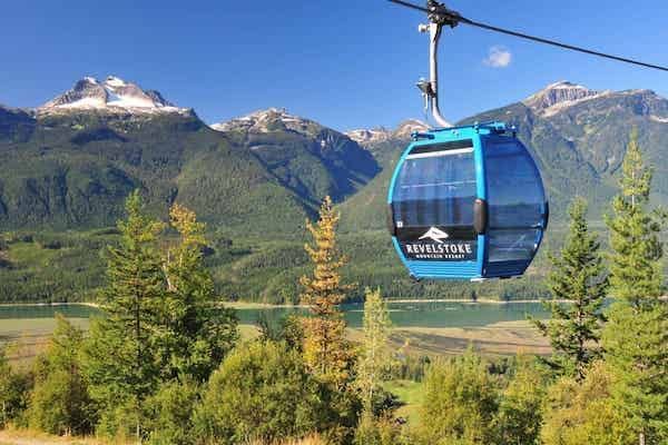 Revelstoke gondola with mountain in the back and green trees below