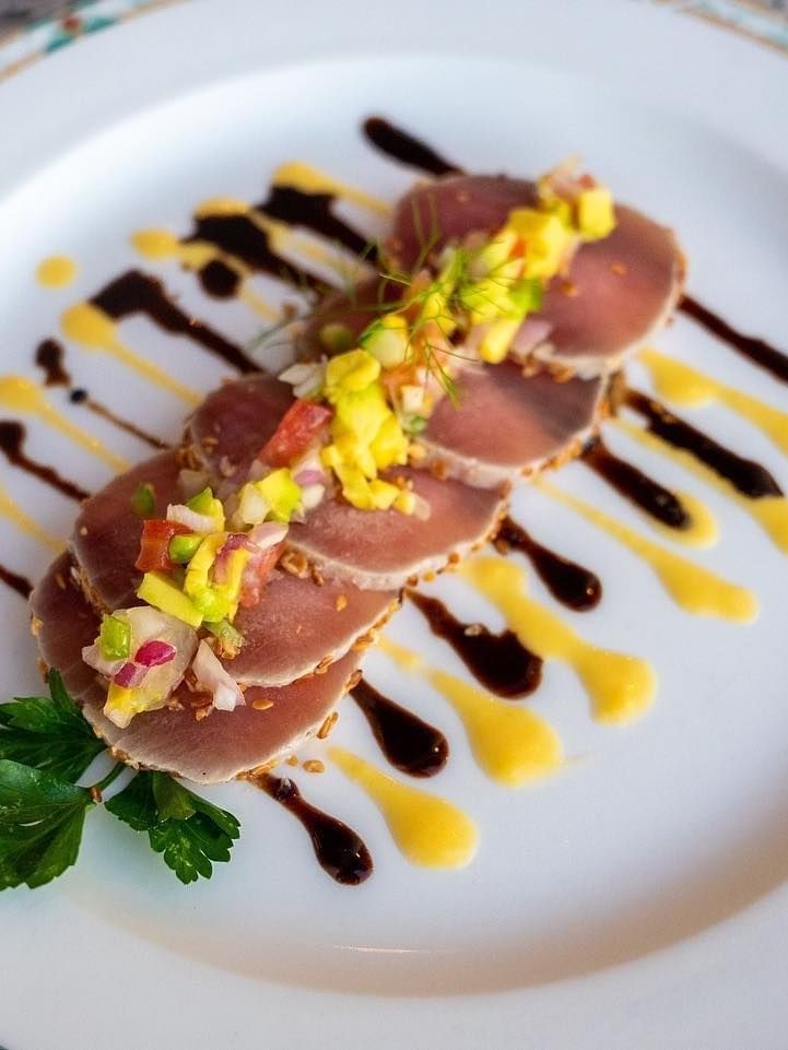 Seafood dish with sauce on a white plate at Zanzibar Serena Hotel in Zanzibar.