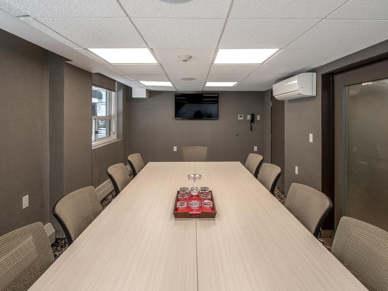 Long table with chairs in a meeting room.