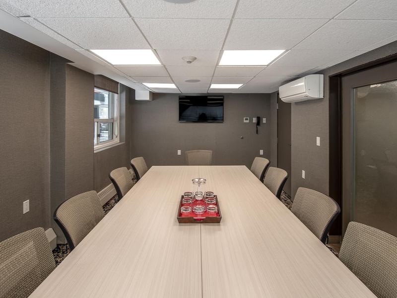 Long table with chairs in a meeting room.