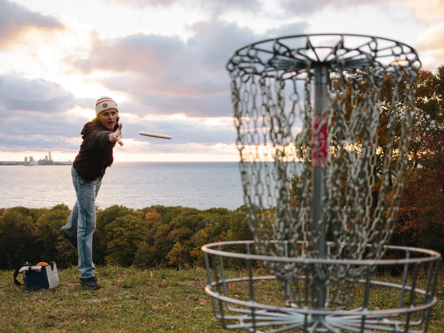 Man playing disc golf in Mt. McSauba recreational area near The Earl