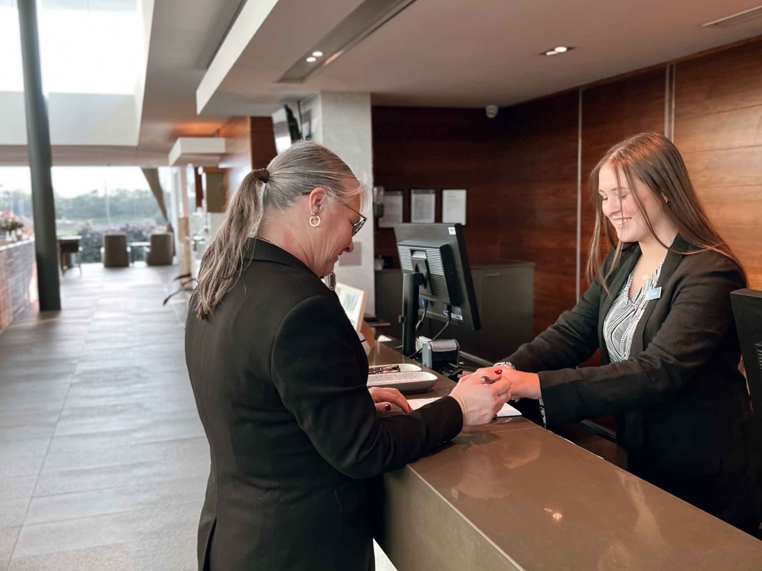 Guest relations checking guest in at reception