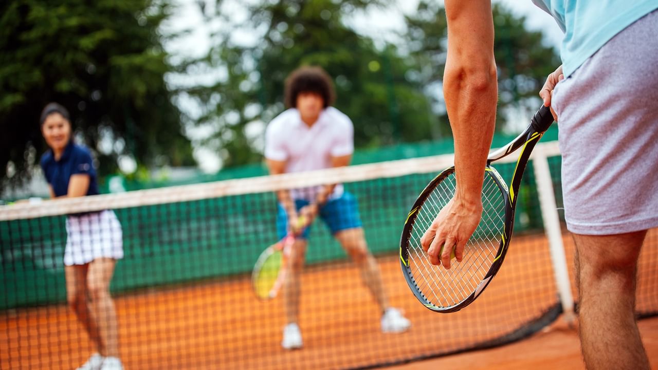 tennis players on a court in summer