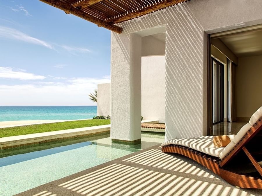 A private terrace in Casita Ocean front at Marquis Los Cabos Resort with a plunge pool and a lounge chair