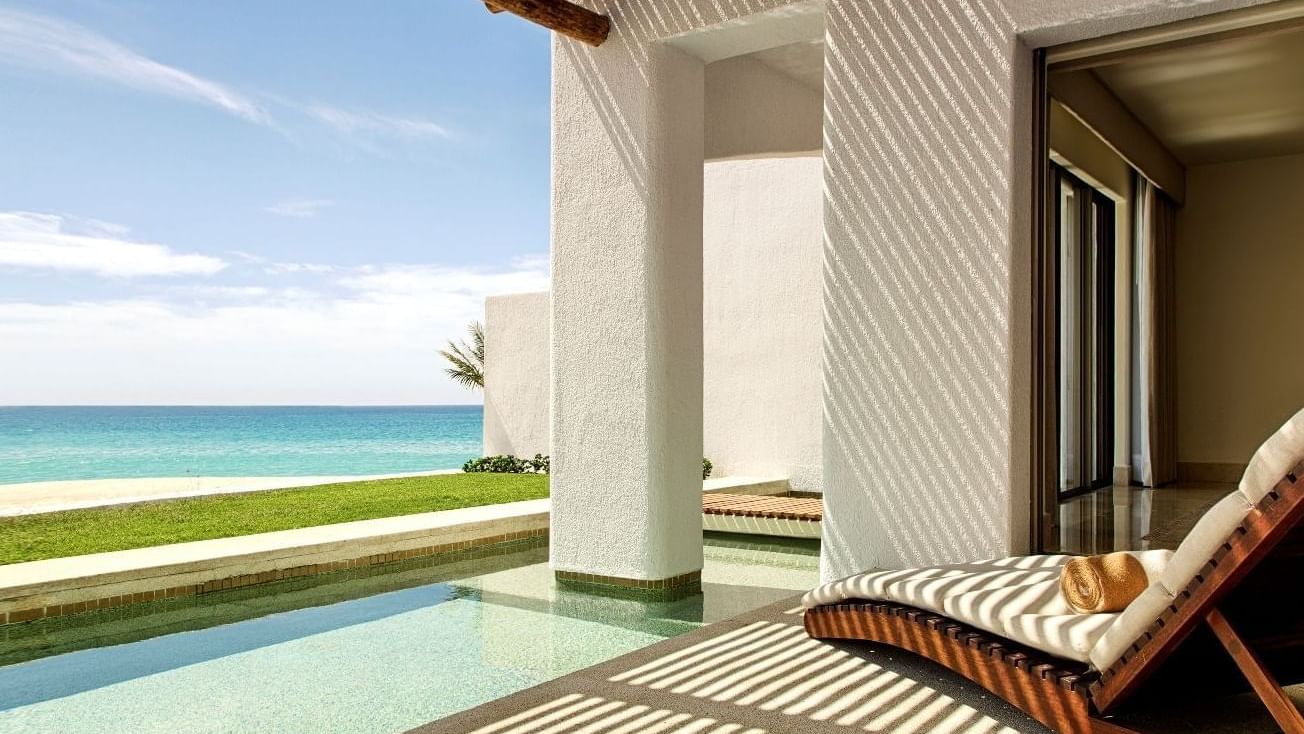 A private terrace in Casita Ocean front at Marquis Los Cabos Resort with a plunge pool and a lounge chair
