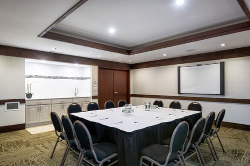 Conference set-up in a Meeting Room with carpeted floors at Blackcomb Springs Suites
