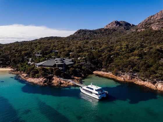 Yacht on the bay near the jetty at  Freycinet Lodge