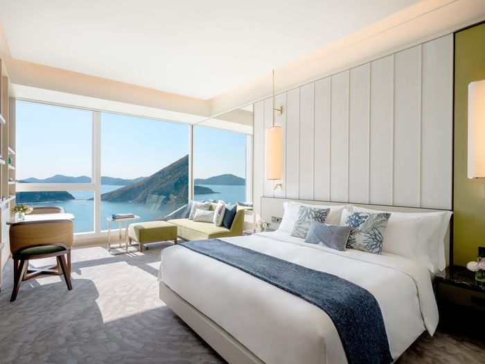 Comfy bed and lounge in Deluxe Oceanfront room at Fullerton Ocean Park Hotel Hong Kong
