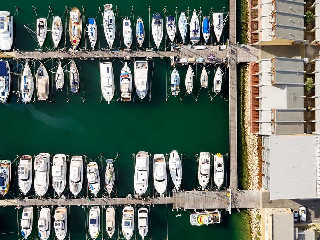 Aerial view of the boats docked by the pier near Be Fremantle
