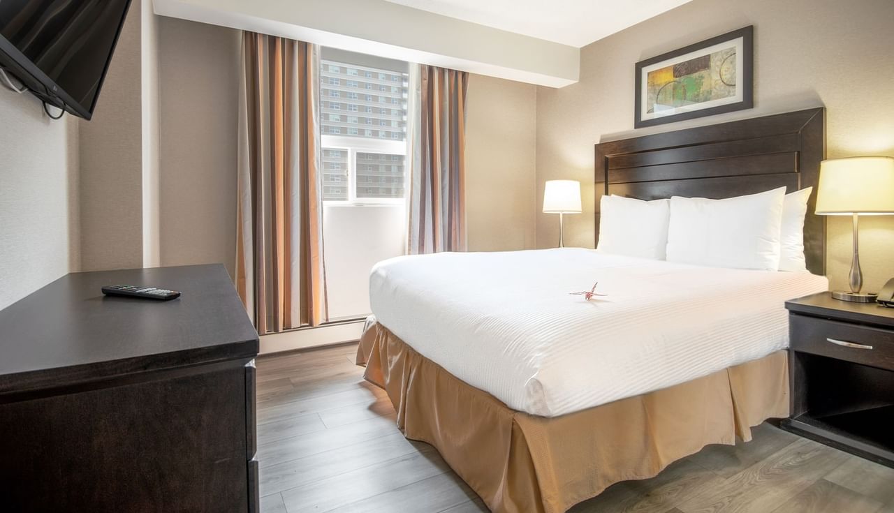 Hotel suite with queen bed and TV