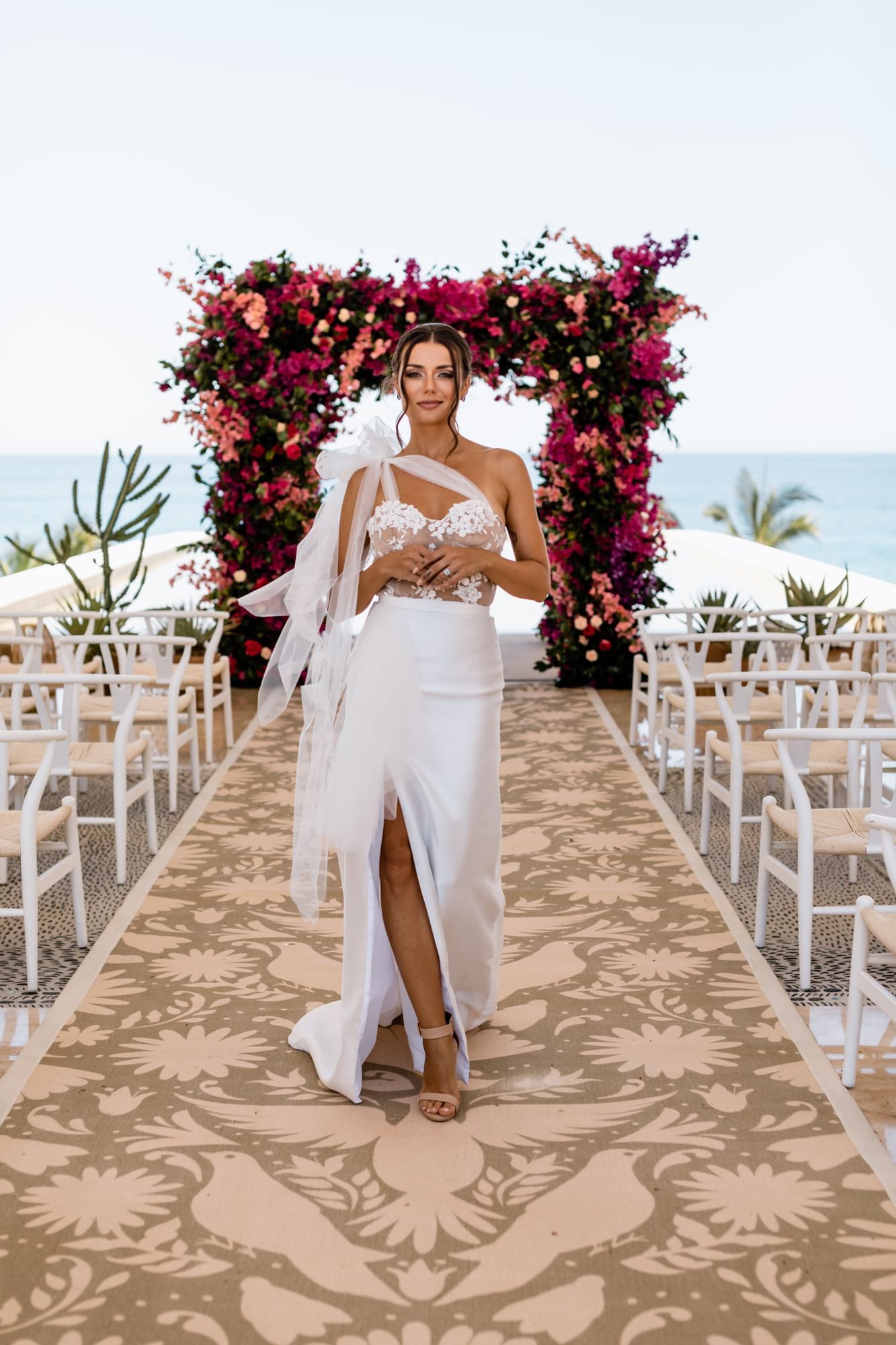 A Bride standing on the isle at Marquis Los Cabos
