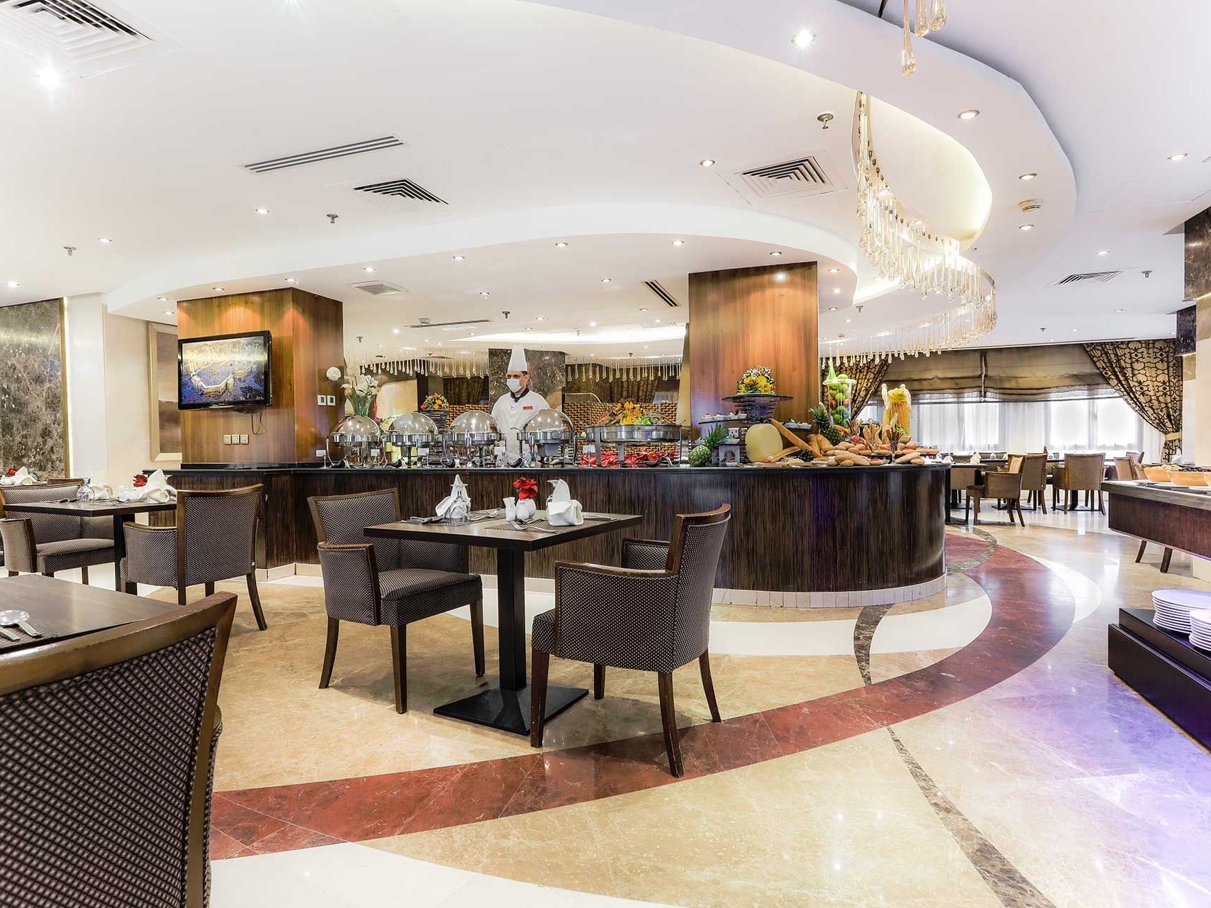 Dining tables, Buffet table & TV screen at Elaf Kinda Hotel