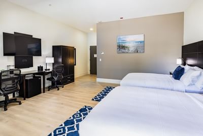 TV & work desk facing king bed in Premier Double Queen Balcony Room at Grant Street Inn