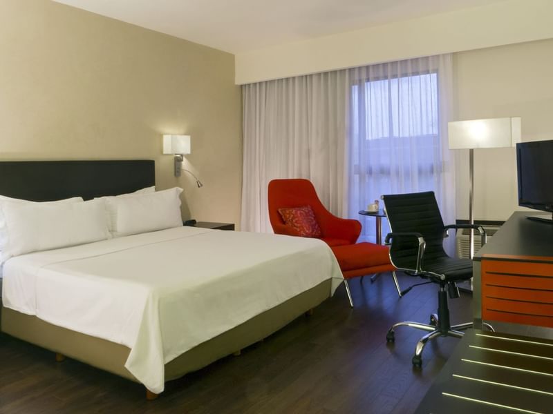 King bed in Superior Room with working desk at Fiesta Inn