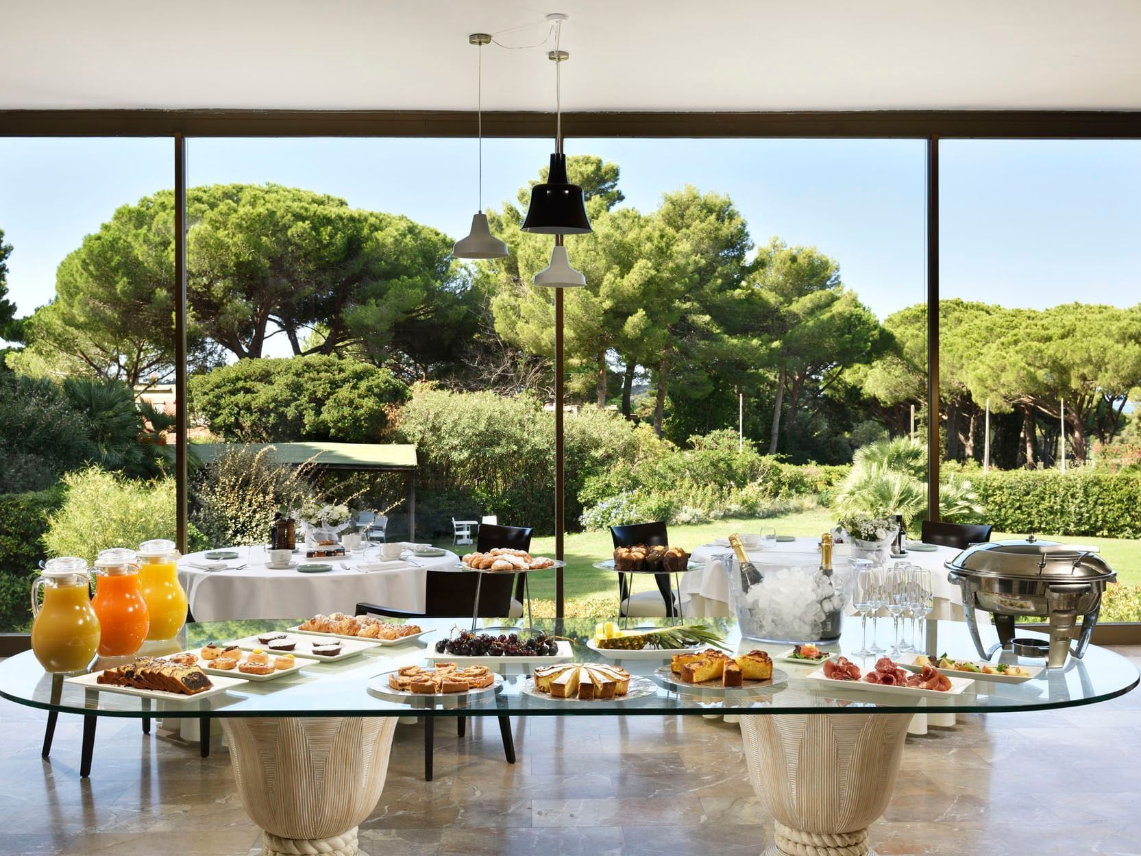 Breakfast buffet arranged with garden view in a Restaurant at Golf Hotel Punta Ala