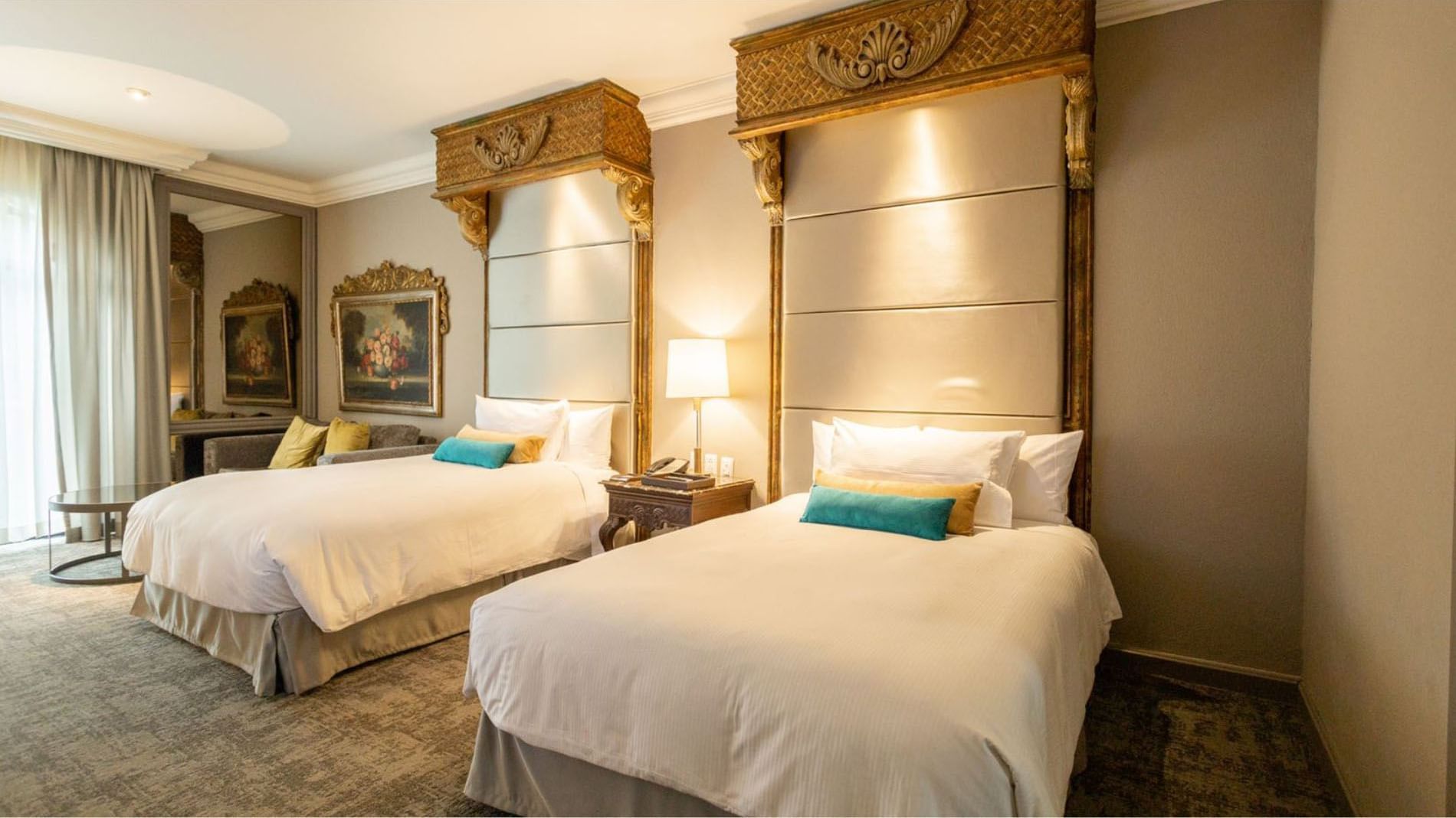 Detailed view of plush beds in 2 Double Grand Class with tall decorative headboards at Quinta Real Monterrey