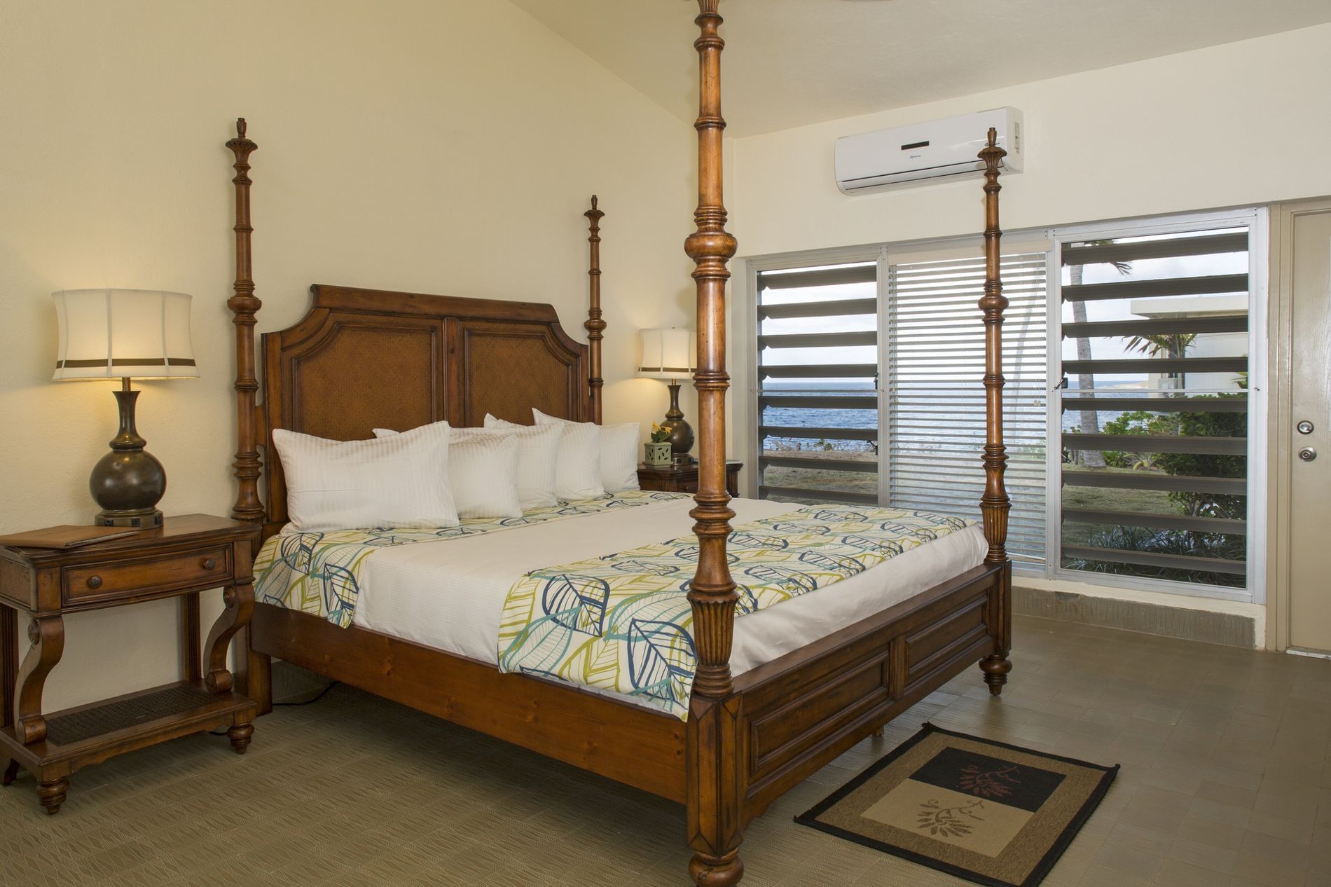 Bed & table lamp with sea view in luxury room at The Buccaneer Resort St. Croix