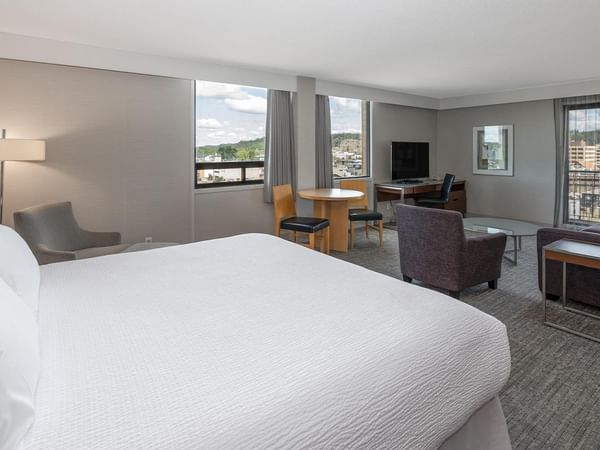Spacious Coast Premium King Junior Suite with king bed, seating area, and city views at Coast Prince George Hotel.