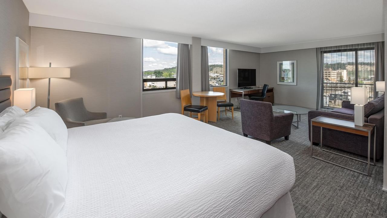 Spacious Coast Premium King Junior Suite with king bed, seating area, and city views at Coast Prince George Hotel.