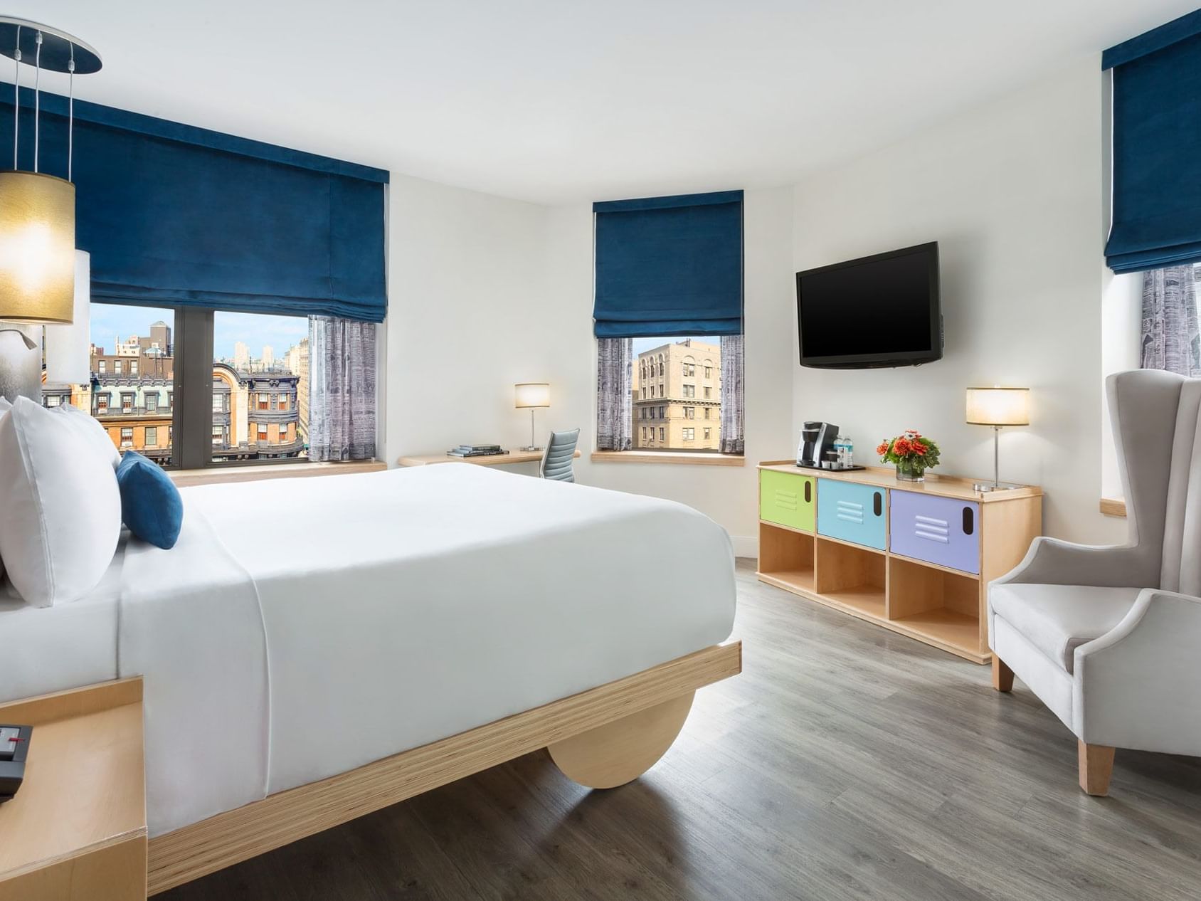 a bed facing a wall-mounted tv
