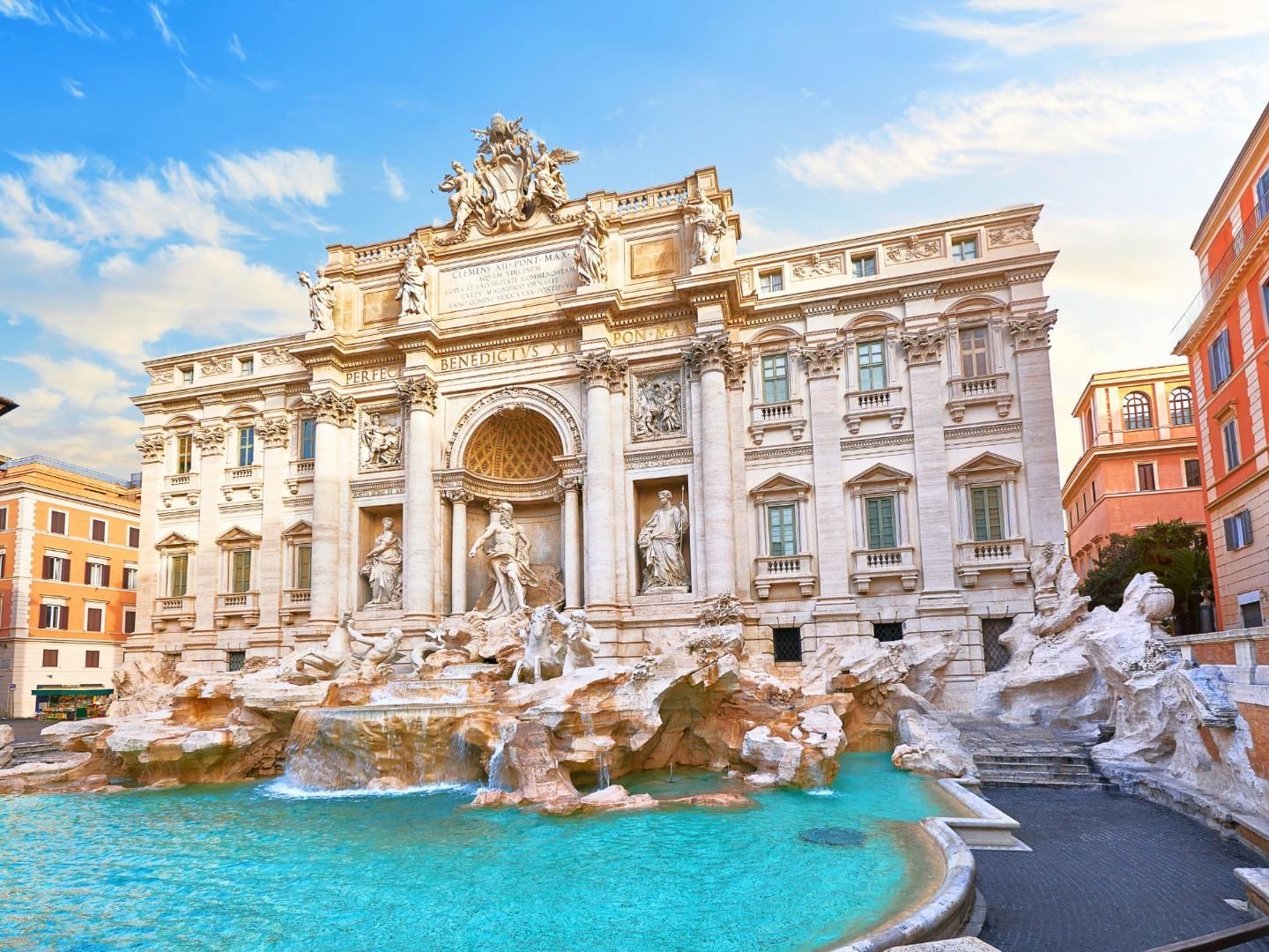 Dazzling Trevi Fountain with grand sculptures, cascading water & pool under a clear sky near The Republic Hotel