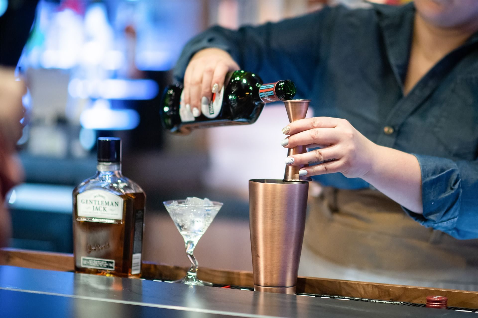 Close-up of a bartender making drinks at The Brook 