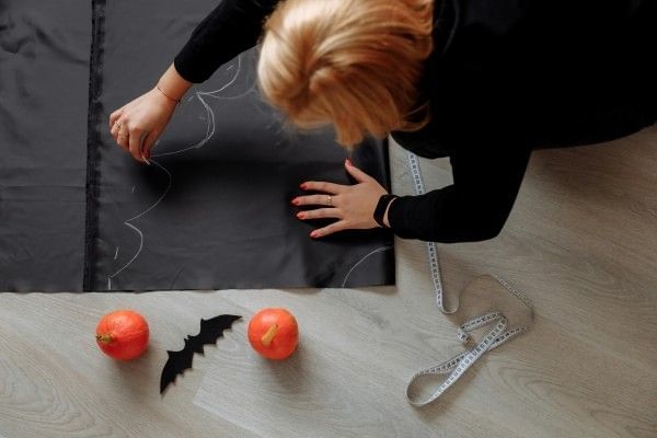 A birds-eye view of a woman creating her own Halloween costume.