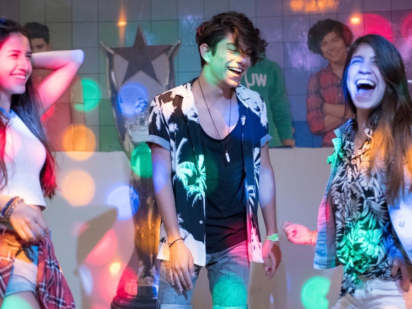 Closeup on a young group dance at a disco in Fiesta Resort