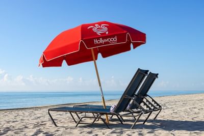 Pair of sunloungers & sunshade at Costa Beach Resort's seaside