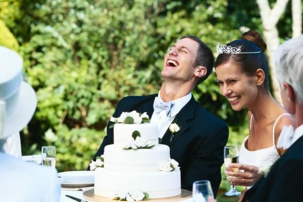 Bride and groom laughing at their amazing wedding entertainment