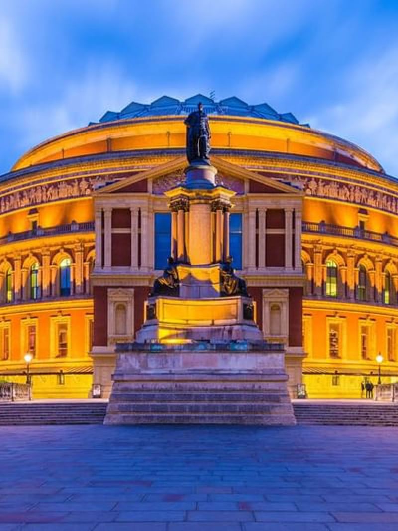 Royal Albert Hall illuminated by warm golden lights at night near The Capital Hotel, Apartments and Townhouse