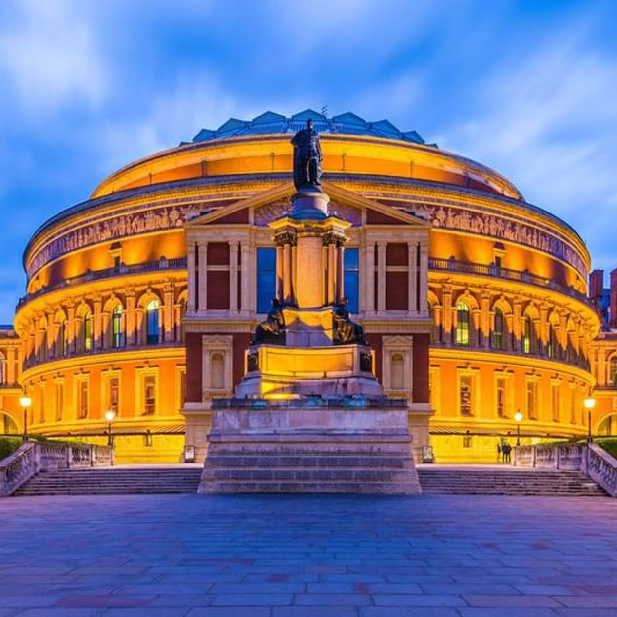 Royal Albert Hall illuminated by warm golden lights at night near The Capital Hotel, Apartments and Townhouse