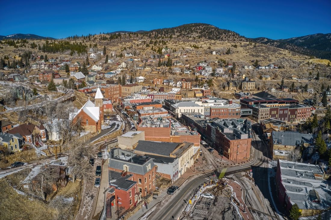 Central City Colorado by a winding road under a large hill near the forest near Warwick Denver