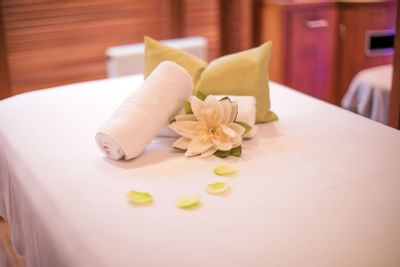 Close-up of a towel & flowers on a spa bed at Liebes Rot Flueh
