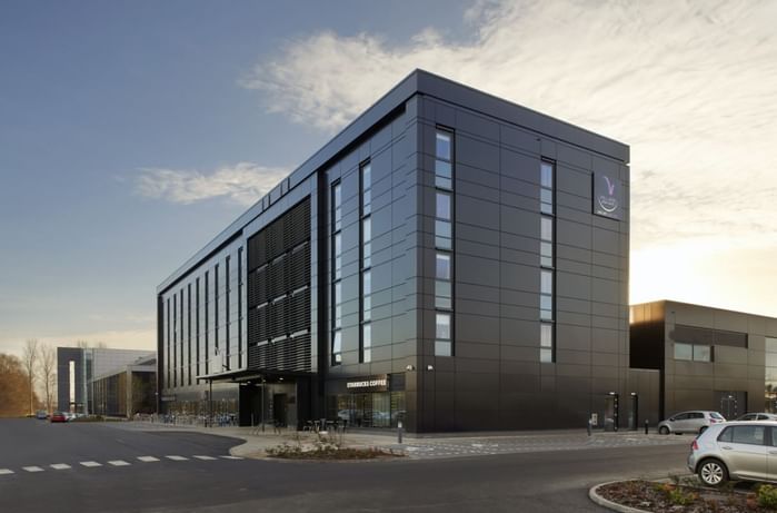 An exterior view of the hotel & car park at Village Hotels