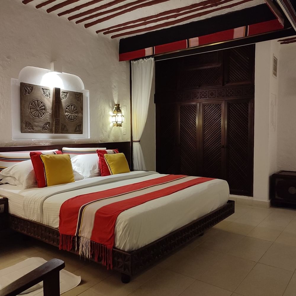 Stylish Superior Room with large bed and wooden features at Serena Beach Resort & Spa in Mombasa.