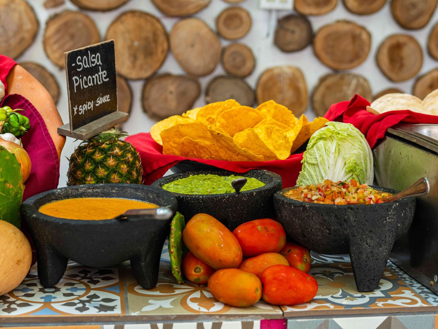 The 3 Cuates Tacos Bar bowls of salsa, guacamole, pico de gallo, fresh produce and tortilla chips.