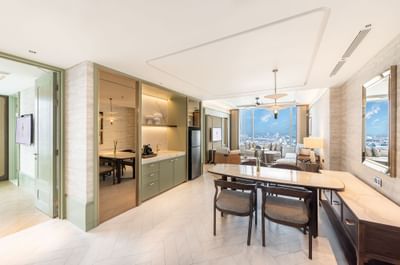 Dining table, coffee station & living area in a suite at Eastin Grand Hotel Phayathai
