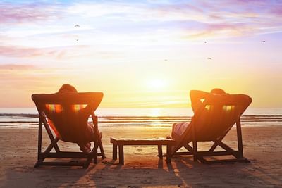 Couple lounging on the Beach near Trianon Bonita Bay