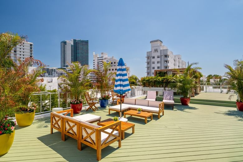 A rooftop deck with outdoor furniture and a city skyline view.
