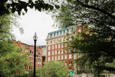 A distant exterior view of The Eliot Hotel during daytime