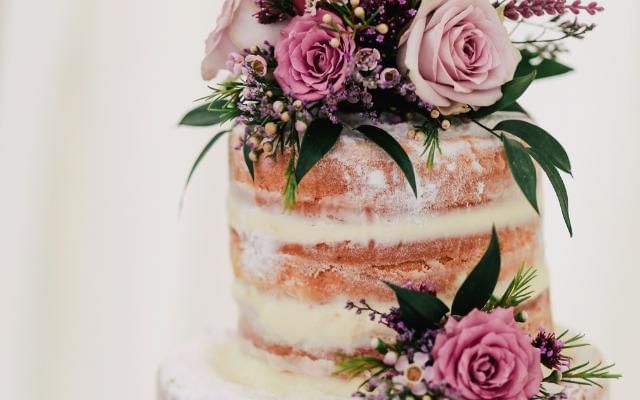 Summer inspired wedding cake with seasonal flowers and rustic charm