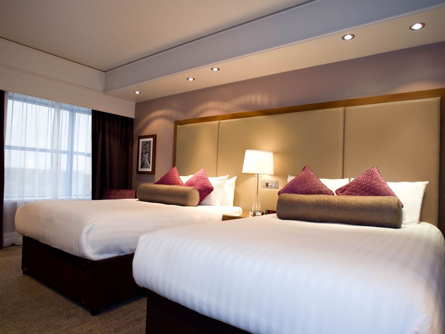 The Two Double Beds Room at Sandman Signature London Gatwick Hotel with two double beds (with premium pillow-top) and lamp shade between the beds
