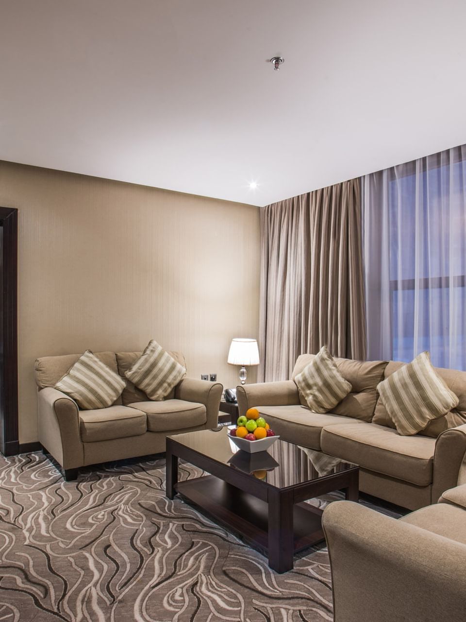Spacious living room with sofas by a fruit tray on a table in Executive Suite Sea View at Naviti by Warwick Al Khobar