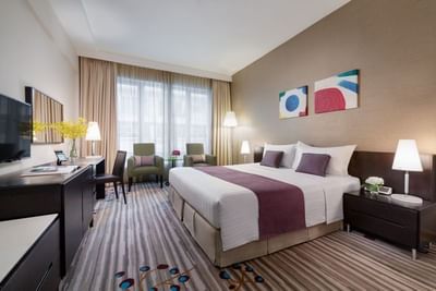 Work desk & lounge area by the bed in Deluxe King Room at Park Hotel Hong Kong